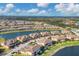 Aerial view of luxury homes and community lake at 12580 Ghiberti Cir # 101, Venice, FL 34293