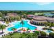 Aerial view of community pool, clubhouse, and landscape at 12580 Ghiberti Cir # 101, Venice, FL 34293