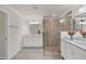 Elegant bathroom with a double vanity and walk-in shower at 12580 Ghiberti Cir # 101, Venice, FL 34293