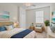 Guest bedroom with wicker furniture and coastal decor at 12580 Ghiberti Cir # 101, Venice, FL 34293