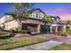 Attractive two-story townhome with a brown garage door and landscaped yard at 12580 Ghiberti Cir # 101, Venice, FL 34293