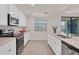 Modern kitchen with white cabinets and stainless steel appliances at 12580 Ghiberti Cir # 101, Venice, FL 34293