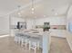 Modern kitchen with white cabinets, stainless steel appliances, and an island at 12580 Ghiberti Cir # 101, Venice, FL 34293