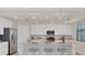 Modern kitchen with white cabinets, granite countertops, and island at 12580 Ghiberti Cir # 101, Venice, FL 34293