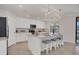 Modern kitchen with white cabinets, stainless steel appliances, and an island at 12580 Ghiberti Cir # 101, Venice, FL 34293
