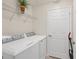 Convenient laundry room with washer, dryer, and shelving at 12580 Ghiberti Cir # 101, Venice, FL 34293