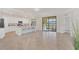 Open living room and kitchen area with tile floors and water views at 12580 Ghiberti Cir # 101, Venice, FL 34293