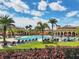 Community pool area with lounge chairs and umbrellas at 12580 Ghiberti Cir # 101, Venice, FL 34293