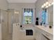Bathroom with soaking tub, shower, and water views at 12953 N Marsh Dr, Port Charlotte, FL 33953