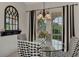 Breakfast nook with glass table and black and white checkered chairs at 12953 N Marsh Dr, Port Charlotte, FL 33953