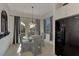 Charming breakfast nook with glass table and black and white chairs at 12953 N Marsh Dr, Port Charlotte, FL 33953
