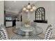 Kitchen dining area with a glass table and black and white chairs at 12953 N Marsh Dr, Port Charlotte, FL 33953
