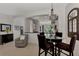 Kitchen and dining area with a glass-top table and modern pendant lighting at 12953 N Marsh Dr, Port Charlotte, FL 33953