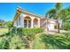 Well-maintained home with lush landscaping and a paver driveway at 12953 N Marsh Dr, Port Charlotte, FL 33953