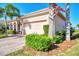 Attached garage with paver driveway and manicured landscaping at 12953 N Marsh Dr, Port Charlotte, FL 33953