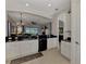Open kitchen with granite countertops and a view to the living room at 12953 N Marsh Dr, Port Charlotte, FL 33953