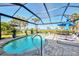 Spacious screened pool and patio with lounge chairs at 12953 N Marsh Dr, Port Charlotte, FL 33953