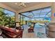 Relaxing screened pool patio with wicker furniture at 12953 N Marsh Dr, Port Charlotte, FL 33953