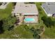 Aerial view showcasing home, pool, and lush landscaping at 145 Bunker Rd, Rotonda West, FL 33947