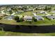 Aerial view of a home with pool, situated on a canal in a golf course community at 145 Bunker Rd, Rotonda West, FL 33947