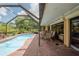 Relaxing pool area with brick patio and screened enclosure at 145 Bunker Rd, Rotonda West, FL 33947