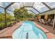 Inviting kidney-shaped pool with screened patio at 145 Bunker Rd, Rotonda West, FL 33947