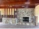 Living room with stone fireplace and wood ceiling at 1467 Deer Creek Dr, Englewood, FL 34223