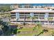 Aerial view of condo building showcasing water views and private balconies at 1551 Beach Rd # 205, Englewood, FL 34223