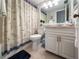 Clean bathroom with nautical shower curtain and granite vanity at 1551 Beach Rd # 205, Englewood, FL 34223