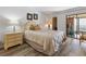 Cozy bedroom with a queen-size bed, nightstand, and built-in wooden dresser at 1551 Beach Rd # 205, Englewood, FL 34223