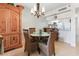 Bright dining area with glass table and four chairs, and a built-in wooden cabinet at 1551 Beach Rd # 205, Englewood, FL 34223