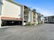 Building exterior with parking and beach access at 1551 Beach Rd # 205, Englewood, FL 34223