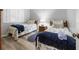 Two twin beds, nightstands, and nautical-themed decor at 1551 Beach Rd # 205, Englewood, FL 34223