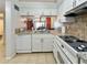 White kitchen with granite countertops, stainless steel appliances, and pantry at 1551 Beach Rd # 205, Englewood, FL 34223
