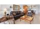 Comfortable living room with leather sofa and chairs, and a glass-top coffee table at 1551 Beach Rd # 205, Englewood, FL 34223