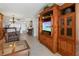 Living room with a wooden entertainment center, offering ample space and storage at 1551 Beach Rd # 205, Englewood, FL 34223
