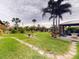 Expansive backyard with stone pathways, lush landscaping, and a gazebo with seating area at 170 Antilla Dr, Rotonda West, FL 33947
