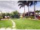 Landscaped backyard oasis featuring a gazebo, stone pathway, and comfortable seating area at 170 Antilla Dr, Rotonda West, FL 33947