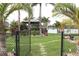 Backyard oasis featuring a gazebo, lush landscaping, and a waterfront view at 170 Antilla Dr, Rotonda West, FL 33947