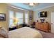 Spacious bedroom with bay window, dresser, and TV at 170 Antilla Dr, Rotonda West, FL 33947