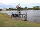Floating dock with a double swing seat, offering peaceful water views at 170 Antilla Dr, Rotonda West, FL 33947