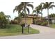 Tan house with palm trees and a landscaped yard at 170 Antilla Dr, Rotonda West, FL 33947