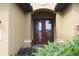 Double front doors with etched glass, surrounded by plants at 170 Antilla Dr, Rotonda West, FL 33947