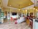 Open living area with hardwood floors, comfy seating, and large TV at 170 Antilla Dr, Rotonda West, FL 33947