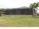 Large screened porch with lush landscaping at 170 Antilla Dr, Rotonda West, FL 33947