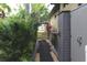 Landscaped side yard with gate access at 170 Antilla Dr, Rotonda West, FL 33947