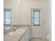 Guest bathroom with single sink vanity and exterior access at 197 Bunker Rd, Rotonda West, FL 33947