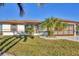Single story home with a brown tile roof and landscaped yard at 197 Bunker Rd, Rotonda West, FL 33947