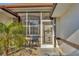 Screened porch entryway with a charming metal door at 197 Bunker Rd, Rotonda West, FL 33947