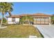 Single story home with a two-car garage and well maintained lawn at 197 Bunker Rd, Rotonda West, FL 33947